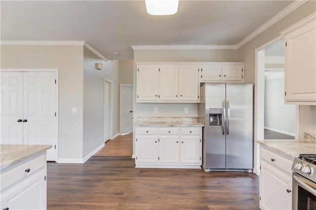 kitchen with white cabinets, dark wood-style flooring, ornamental molding, and appliances with stainless steel finishes