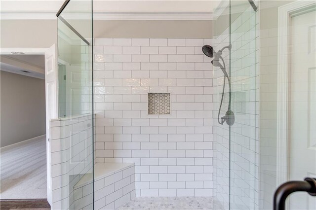 full bath with ornamental molding and a stall shower