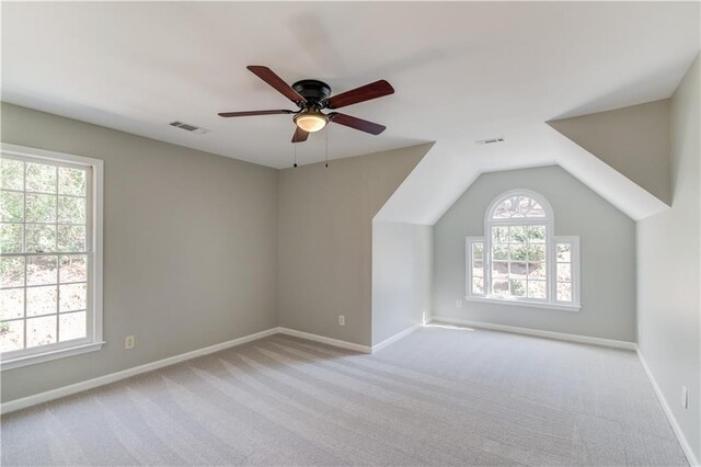 bonus room with carpet, baseboards, ceiling fan, and visible vents