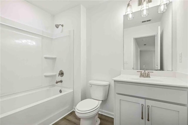 full bathroom with vanity, wood-type flooring,  shower combination, and toilet