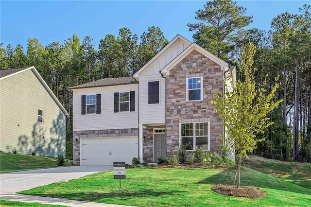 view of front of home with a front yard and a garage