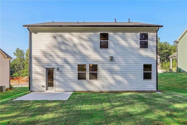 back of property with a yard, a patio, and central air condition unit