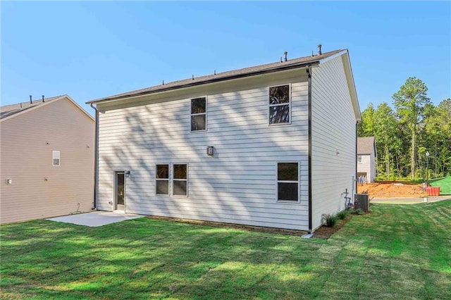 back of house featuring a patio area, a yard, and central AC