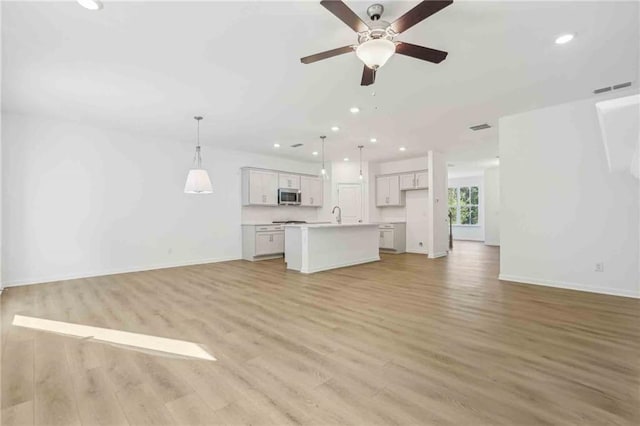 unfurnished living room with light hardwood / wood-style floors and ceiling fan