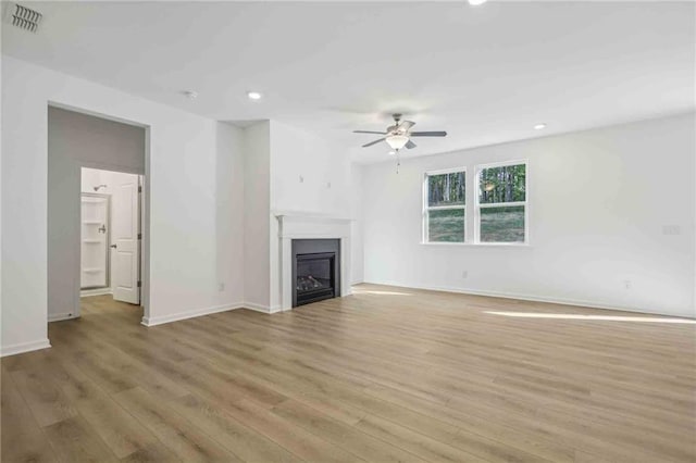 unfurnished living room with light hardwood / wood-style flooring and ceiling fan