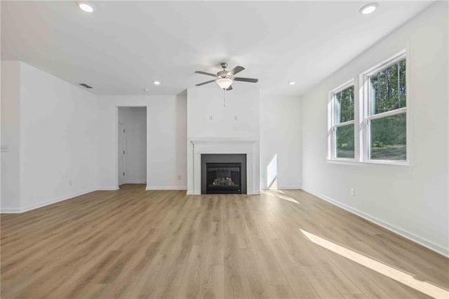 unfurnished living room with light hardwood / wood-style floors and ceiling fan