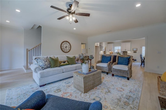 living area featuring a ceiling fan, light wood-type flooring, and recessed lighting