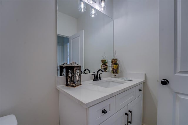 half bathroom with vanity and toilet