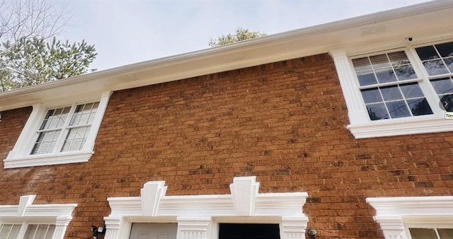 view of side of home featuring brick siding