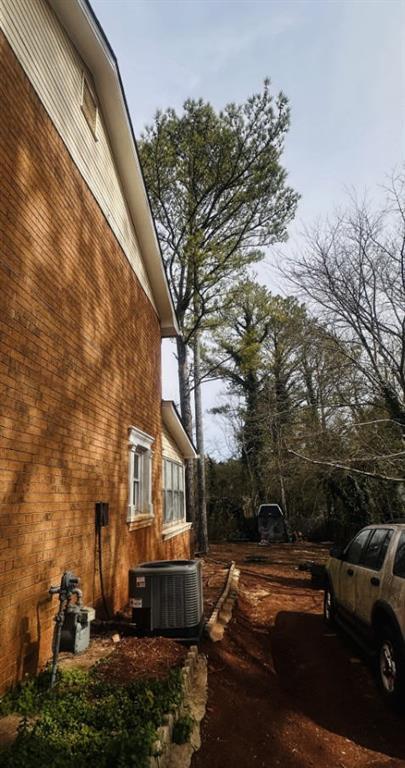 view of side of property with central AC unit