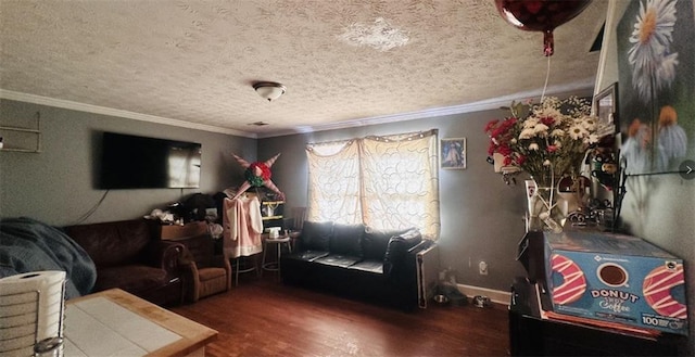 living room with ornamental molding, a textured ceiling, baseboards, and wood finished floors