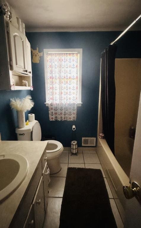 full bathroom featuring visible vents, toilet, vanity, baseboards, and tile patterned floors