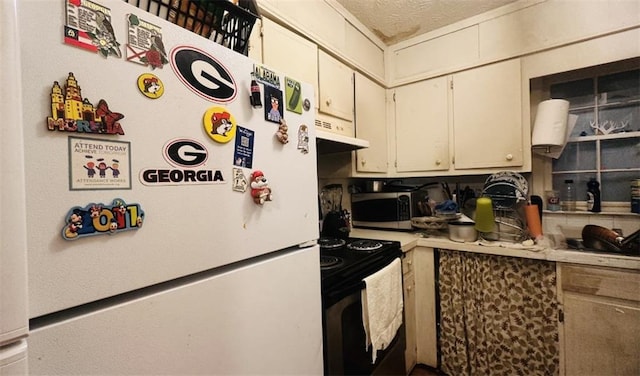 kitchen with appliances with stainless steel finishes, light countertops, and under cabinet range hood