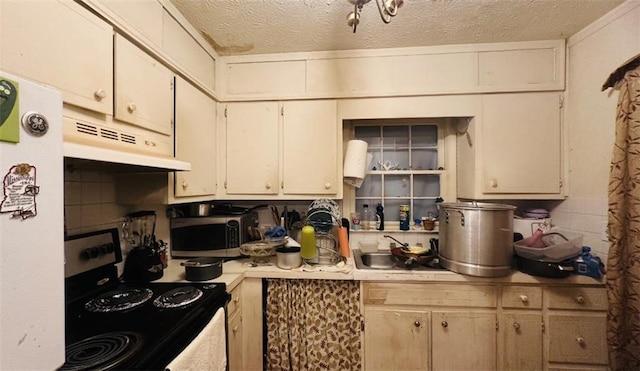 kitchen with range with electric cooktop, stainless steel microwave, light countertops, a textured ceiling, and under cabinet range hood