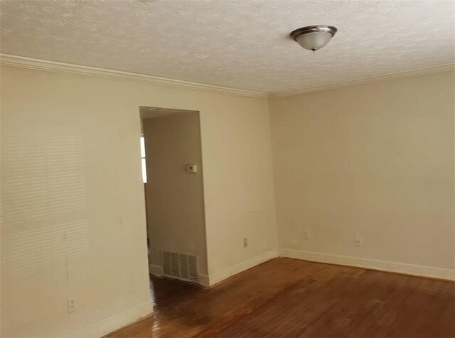 empty room with a textured ceiling, crown molding, and dark hardwood / wood-style floors