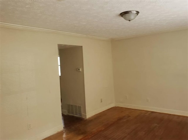 spare room featuring baseboards, a textured ceiling, visible vents, and wood finished floors