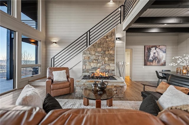 799 Bruce Mountain Rd, Morganton, GA 30560 - living room featuring wood finished floors, plenty of natural light, stairway, wooden walls, and beamed ceiling