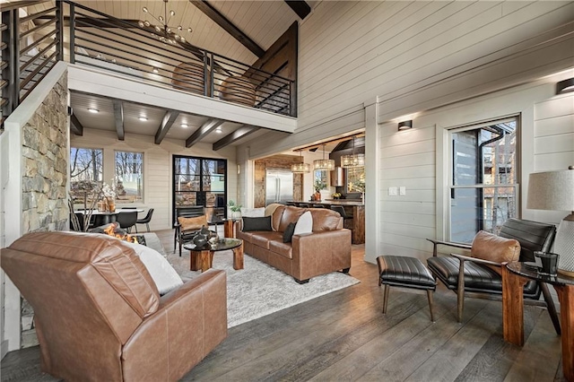 799 Bruce Mountain Rd, Morganton, GA 30560 - living area with wood finished floors, beam ceiling, high vaulted ceiling, wooden walls, and healthy amount of natural light
