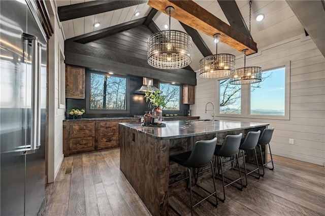 799 Bruce Mountain Rd, Morganton, GA 30560 - kitchen with stainless steel built in fridge, a chandelier, hardwood / wood-style flooring, wood walls, and a center island with sink