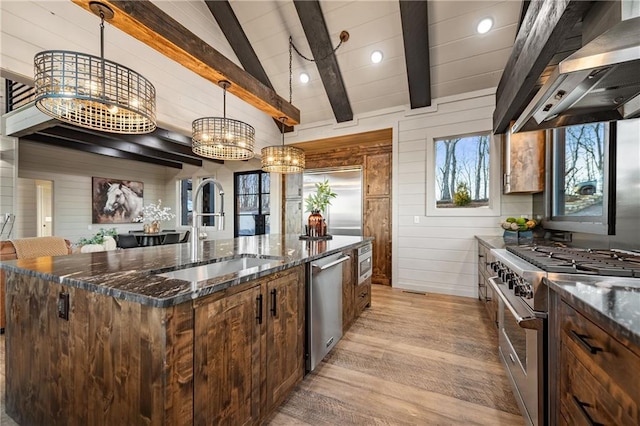 799 Bruce Mountain Rd, Morganton, GA 30560 - kitchen with stainless steel appliances, a sink, wall chimney range hood, light wood-type flooring, and a chandelier