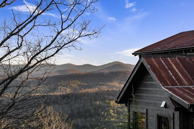 view of property exterior with an outbuilding and a mountain view