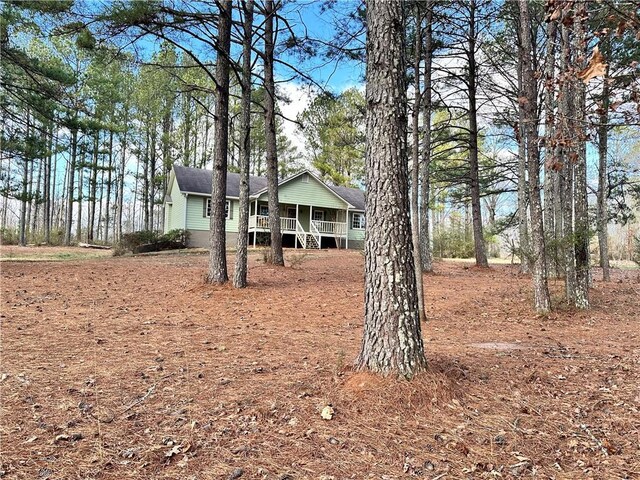 view of yard featuring covered porch