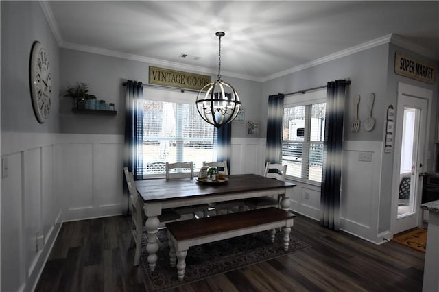 dining room with dark wood finished floors, an inviting chandelier, visible vents, and wainscoting