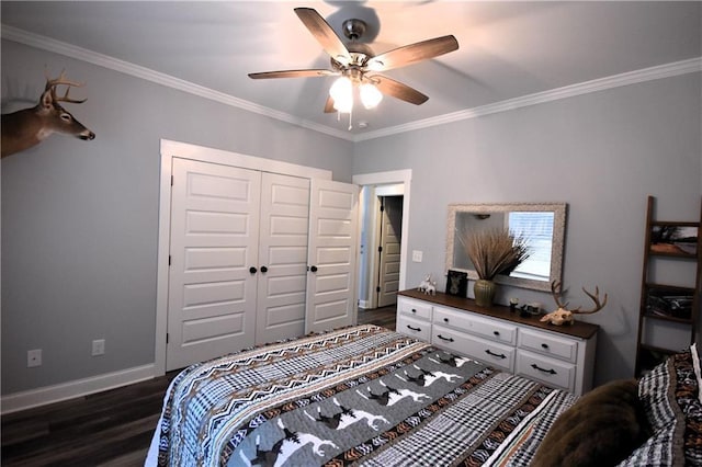 bedroom featuring a closet, baseboards, dark wood-style floors, and ornamental molding