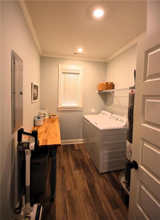 laundry room with dark wood-style floors, baseboards, washing machine and clothes dryer, laundry area, and crown molding