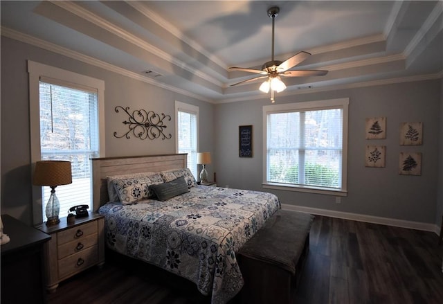 bedroom with baseboards, a raised ceiling, ornamental molding, and dark wood-style flooring