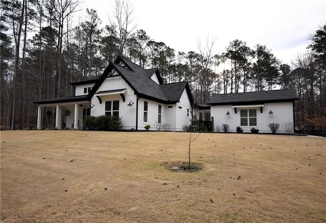 modern farmhouse style home featuring board and batten siding and a front lawn