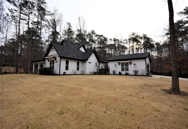 view of front of home featuring board and batten siding and a front yard