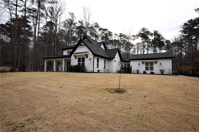 modern farmhouse style home featuring board and batten siding and a front yard