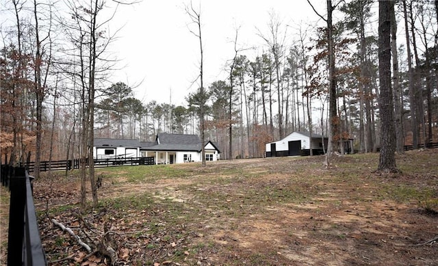 view of yard with an outbuilding and fence