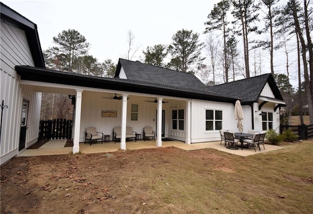 back of house featuring a patio, board and batten siding, roof with shingles, and ceiling fan