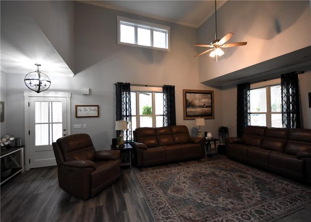 living area with dark wood-style floors, ceiling fan with notable chandelier, and a wealth of natural light