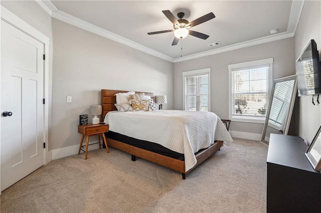 bedroom featuring ornamental molding, light colored carpet, and ceiling fan