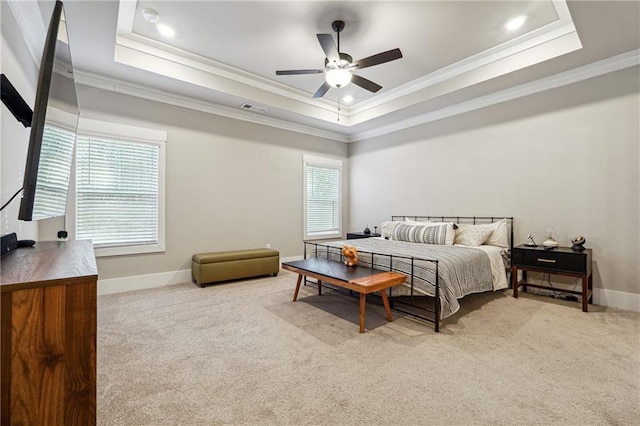 carpeted bedroom featuring a raised ceiling, ceiling fan, and crown molding