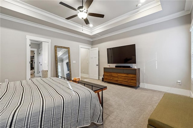 carpeted bedroom with ceiling fan, crown molding, and a tray ceiling