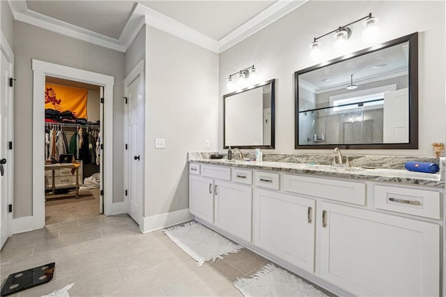 bathroom with tile patterned flooring, a shower with door, crown molding, and vanity