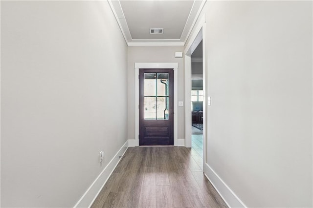 entryway with hardwood / wood-style flooring and crown molding