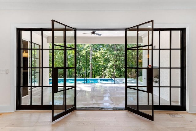 doorway to outside with ceiling fan and light hardwood / wood-style floors