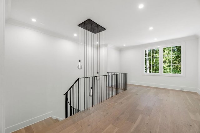 interior space featuring ornamental molding and hardwood / wood-style flooring