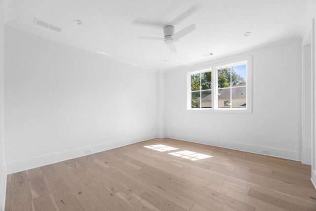 empty room with ceiling fan and light hardwood / wood-style floors