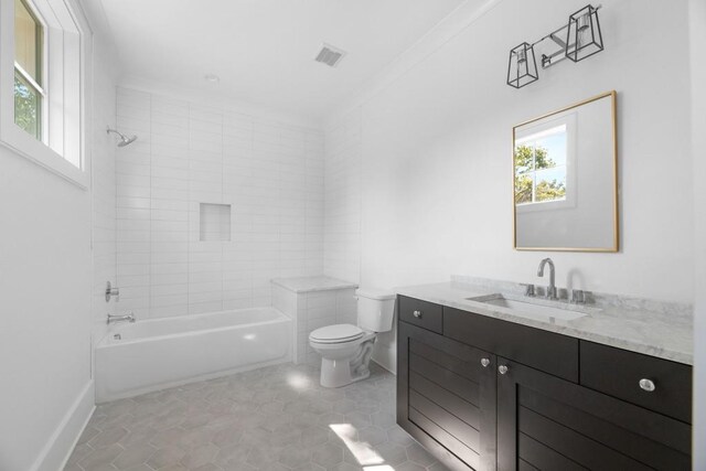 full bathroom with tiled shower / bath, vanity, toilet, and tile patterned floors