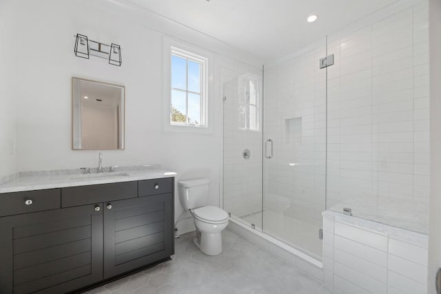 bathroom with vanity, toilet, tile patterned flooring, and a shower with door