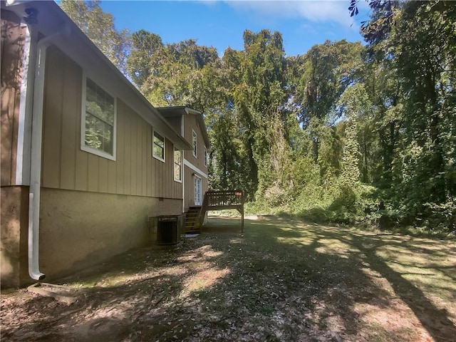 view of yard featuring cooling unit and a wooden deck