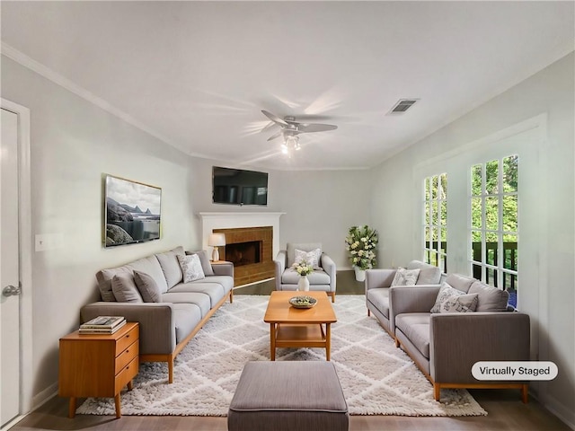 living room featuring wood-type flooring and ceiling fan