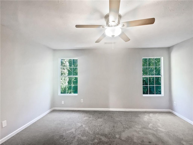 unfurnished room featuring carpet, ceiling fan, and plenty of natural light