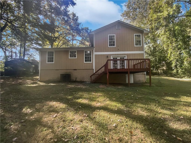 back of house featuring a wooden deck, a yard, and central air condition unit